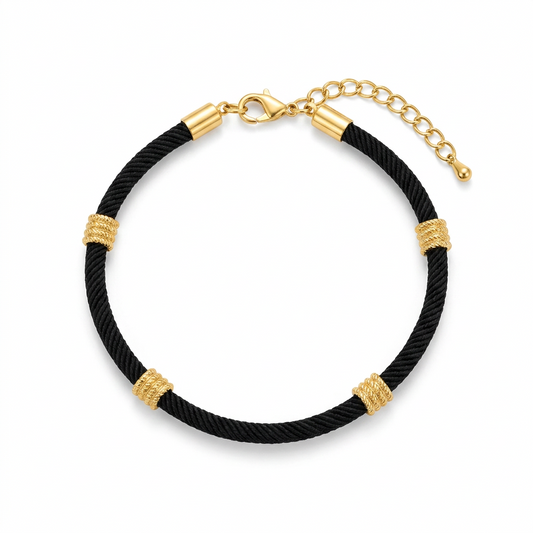 A black string evil eye bracelet with gold-plated accents and clasp