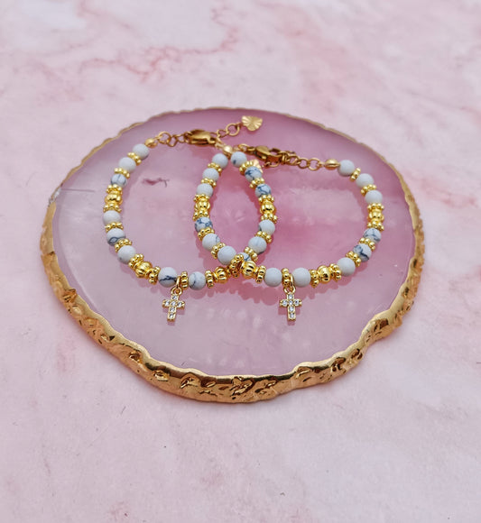 A Pair of Baby Bracelets With Cross Charms