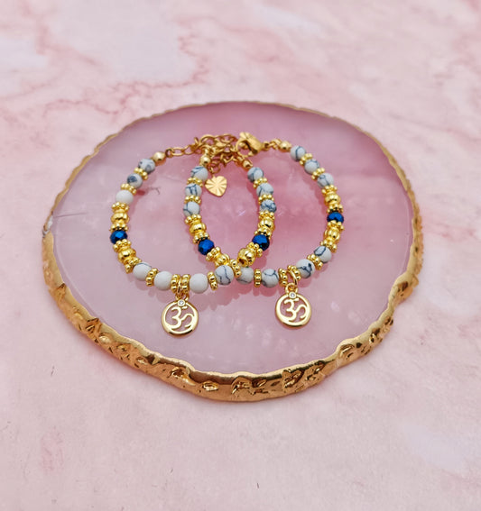 A Pair of Baby Bracelets with Hindi Aum Charms